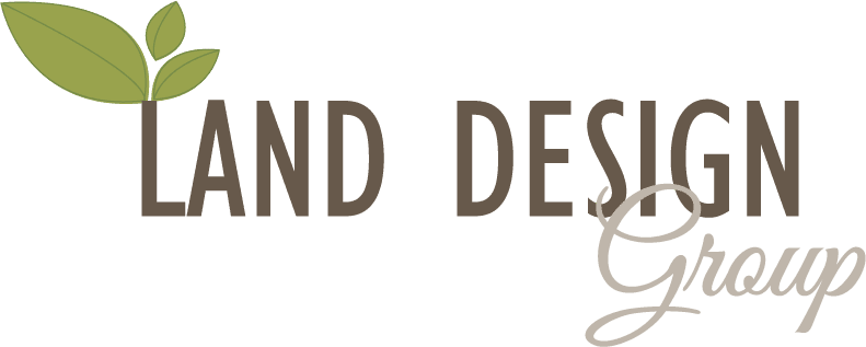 Logo for Land Design Group with green leaves above the "L" in "Land" and the word "Group" in a cursive font.
